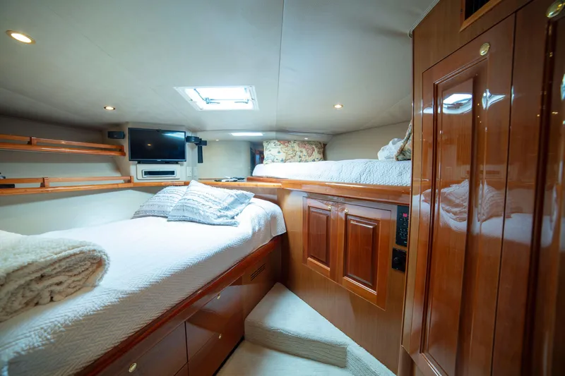 Slide: The Image of Luxurious cabin interior of 2002 Viking 65 Enclosed Bridge yacht with cozy bedding. - 74