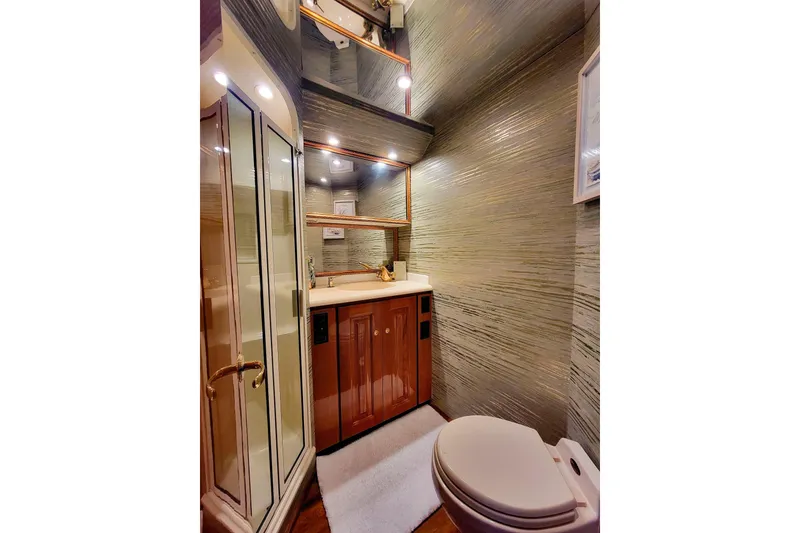 Slide: The Image of Luxurious bathroom in 2002 Viking 65 Enclosed Bridge yacht with modern fixtures and elegant design. - 76