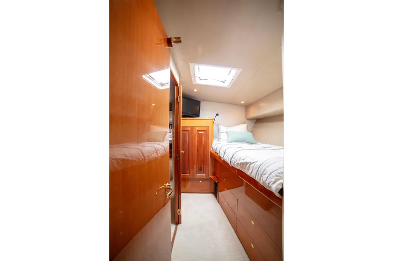 Slide: The Image of Cozy cabin interior of 2002 Viking 65 Enclosed Bridge yacht with wooden finishes. - 78