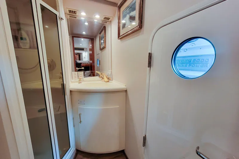Slide: The Image of Bathroom interior of 2002 Viking 65 Enclosed Bridge yacht with shower and vanity. - 83
