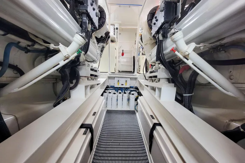 Slide: The Image of Engine room of 2002 Viking 65 Enclosed Bridge yacht, showcasing mechanical components and systems. - 88