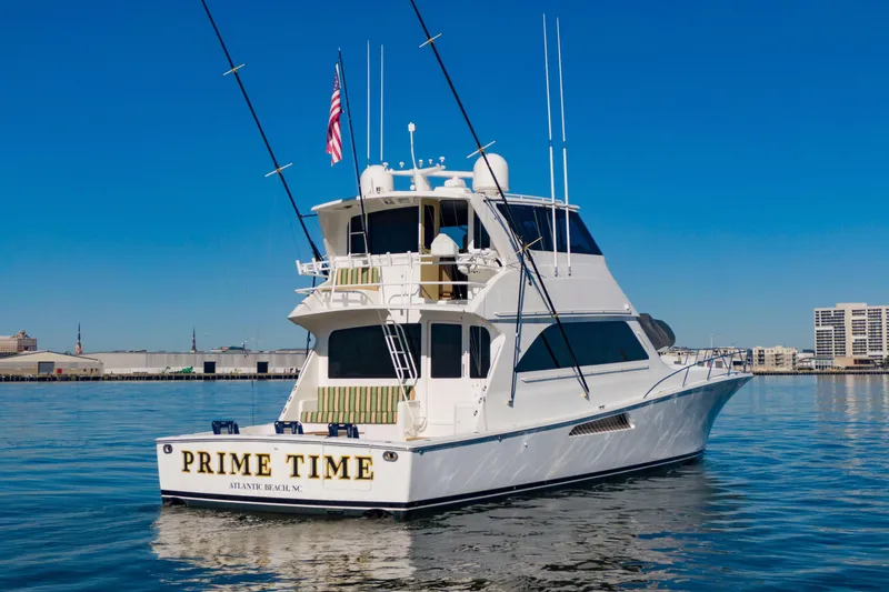Slide: The Image of 2002 Viking 65 Enclosed Bridge yacht "Prime Time" on calm water, clear sky. - 9