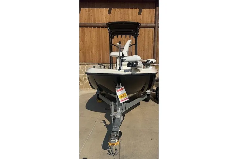 Slide: The Image of 2020 Bayliner Element F21 boat on trailer, displayed outdoors. - 2