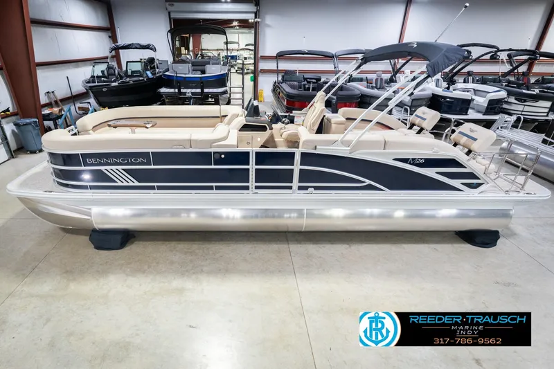 The Image of 2026 Bennington 26 MSL pontoon boat in showroom, side view, beige seating, Reeder-Trausch Marine. - 0