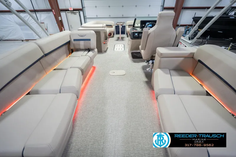 Slide: The Image of 2026 Bennington 26 MSL boat interior with beige seating and ambient lighting. - 19