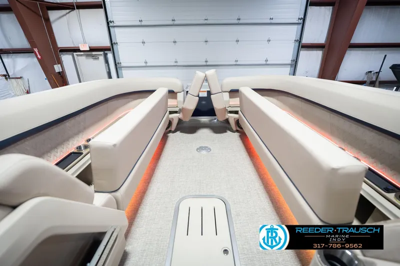 Slide: The Image of 2026 Bennington 26 MSL boat interior with beige seating and ambient lighting. - 23