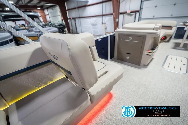 Slide: The Image of 2026 Bennington 26 MSL boat interior with beige seating and ambient lighting. - 32