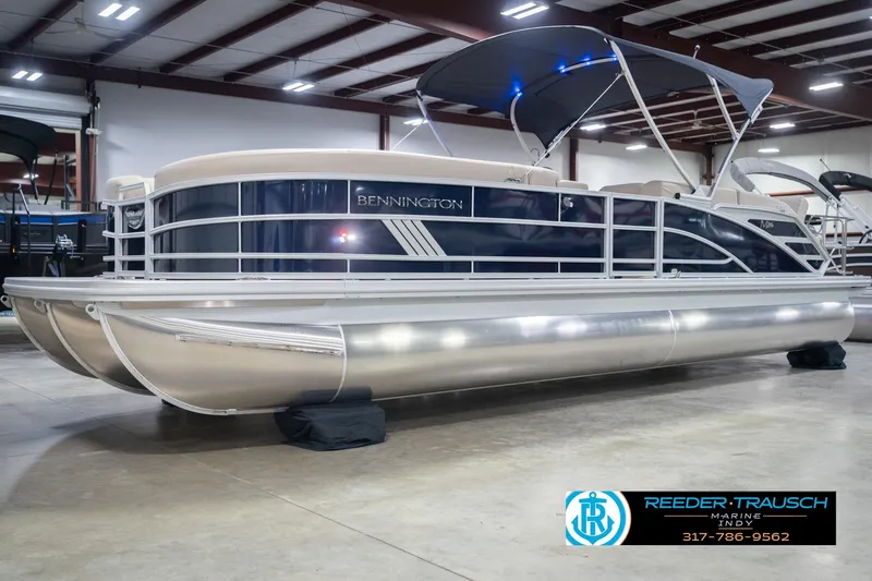 Slide: The Image of 2026 Bennington 26 MSL pontoon boat in showroom with canopy and sleek design. - 4