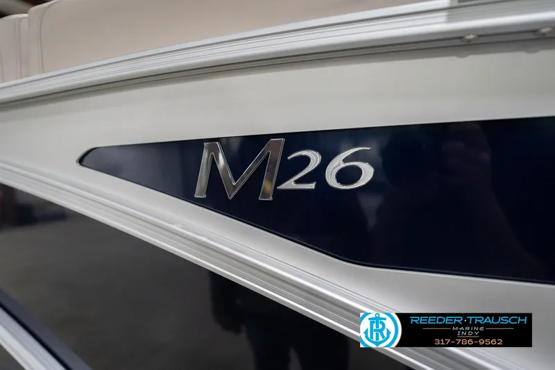 Slide: The Image of 2026 Bennington 26 MSL boat with "M26" emblem, Reeder Trausch Marine logo visible. - 57