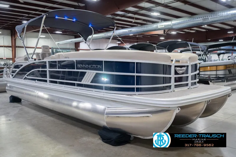 Slide: The Image of 2026 Bennington 26 MSL pontoon boat in showroom, featuring sleek design and modern amenities. - 6