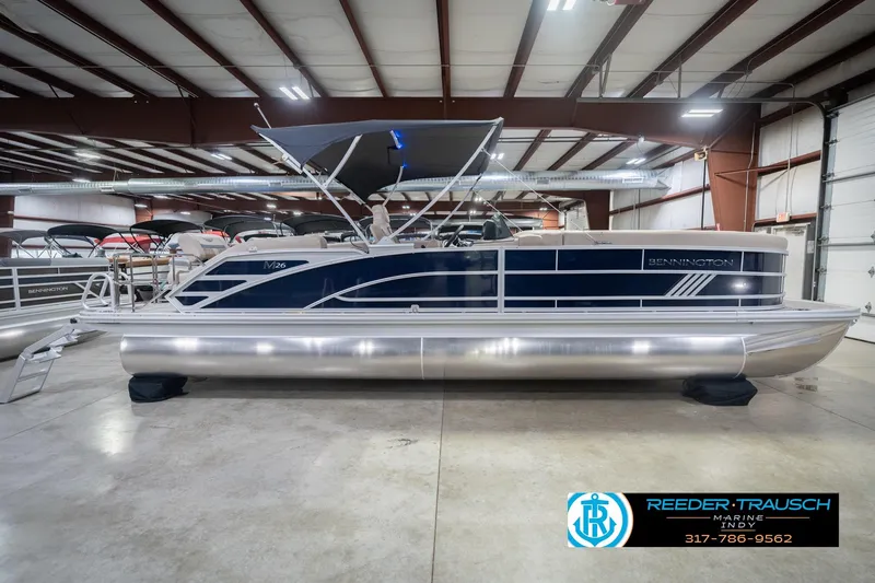 Slide: The Image of 2026 Bennington 26 MSL pontoon boat in showroom, featuring sleek design and modern amenities. - 7