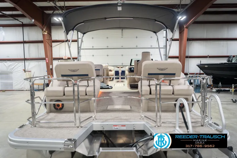 Slide: The Image of 2026 Bennington 26 MSL pontoon boat in a showroom with seating and canopy. - 9