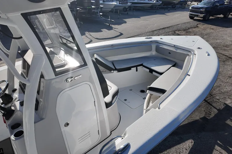 Slide: The Image of 2025 Sea Pro 262 Offshore boat interior with seating and console, docked outdoors. - 10