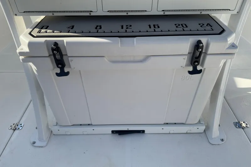 Slide: The Image of 2025 Sea Pro 262 Offshore boat cooler with measurement scale on top. - 22