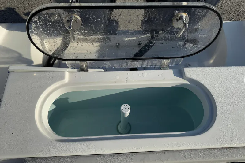 Slide: The Image of Livewell on 2025 Sea Pro 262 Offshore boat, open lid, filled with water. - 24