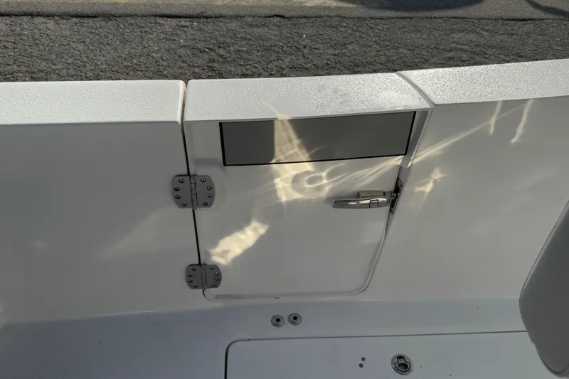 Slide: The Image of 2025 Sea Pro 262 Offshore boat hatch with reflective water patterns. - 25