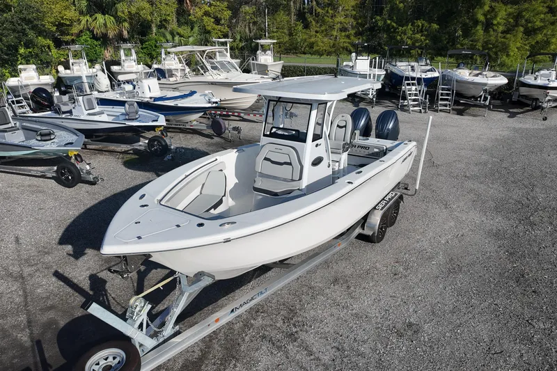 Slide: The Image of 2025 Sea Pro 262 Offshore boat on trailer, surrounded by other boats in a lot. - 4