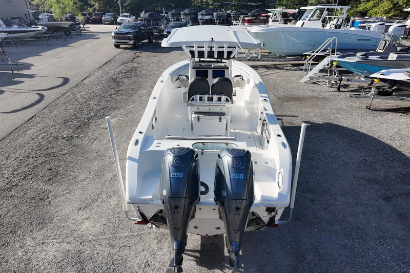 Slide: The Image of 2025 Sea Pro 262 Offshore boat with dual Yamaha 200 engines, parked outdoors. - 7