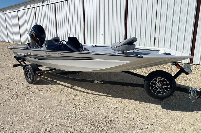Slide: The Image of 2026 G3 Sportsman 1710SE fishing boat on trailer, parked outdoors. - 1