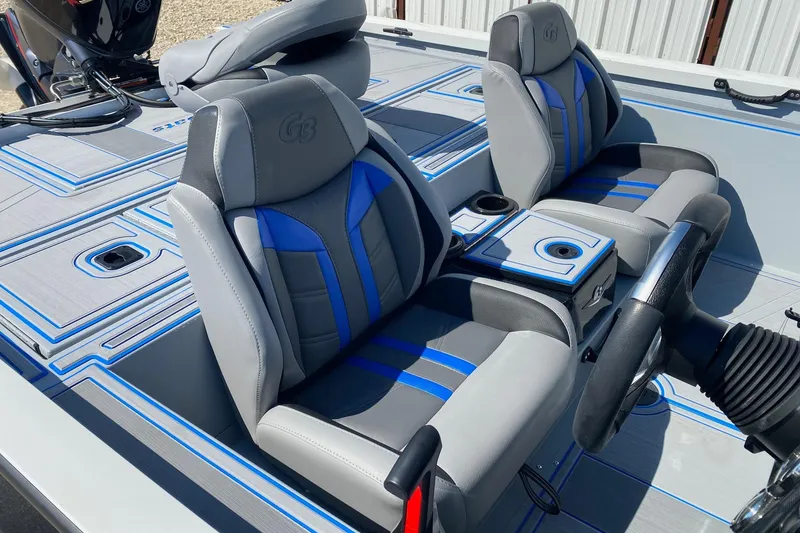 Slide: The Image of 2026 G3 Sportsman 1710SE boat interior with gray and blue seating, steering wheel, and console. - 12