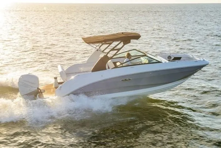 Slide: The Image of 2019 Sea Ray SDX 250 Outboard cruising on open water at sunset. - 53