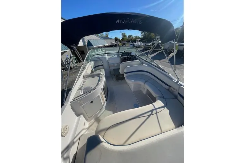 Slide: The Image of 2001 Four Winns 285 Sundowner boat with spacious seating and canopy. - 6