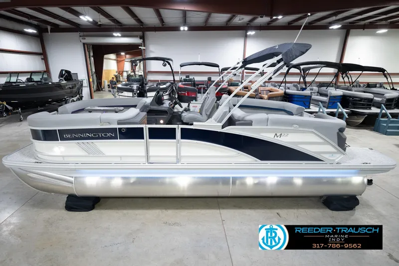 The Image of 2026 Bennington 22 MFB pontoon boat in showroom, featuring sleek design and modern amenities. - 2