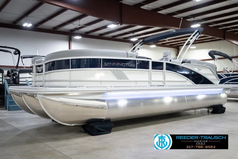 Slide: The Image of 2026 Bennington 22 MFB pontoon boat in showroom, featuring sleek design and modern amenities. - 3