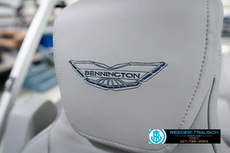 Slide: The Image of Close-up of 2026 Bennington 22 MFB seat with embroidered logo, Reeder-Trausch Marine contact details. - 44