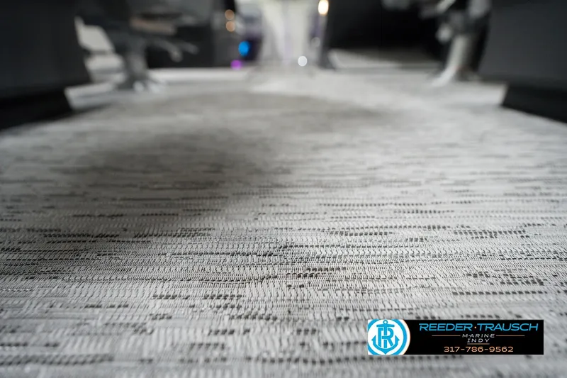 Slide: The Image of Carpeted floor of a 2026 Bennington 22 MFB boat, featuring Reeder-Trausch Marine logo. - 50