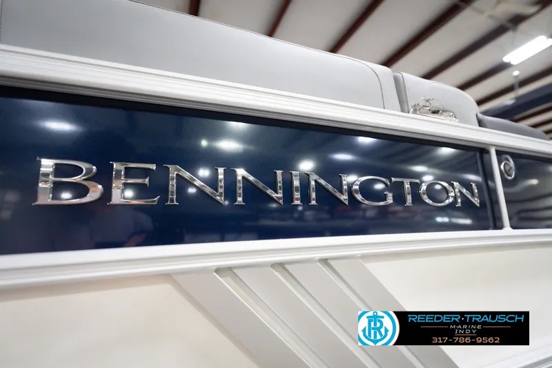 Slide: The Image of 2026 Bennington 22 MFB boat with sleek design and branding in showroom. - 52
