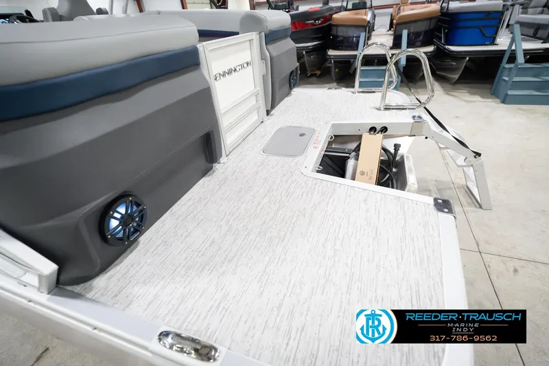 Slide: The Image of 2026 Bennington 22 MFB boat interior with open storage compartment and speaker. - 55