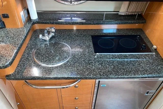Slide: The Image of 2007 Chaparral 330 Signature yacht kitchen with granite countertops and modern appliances. - 15
