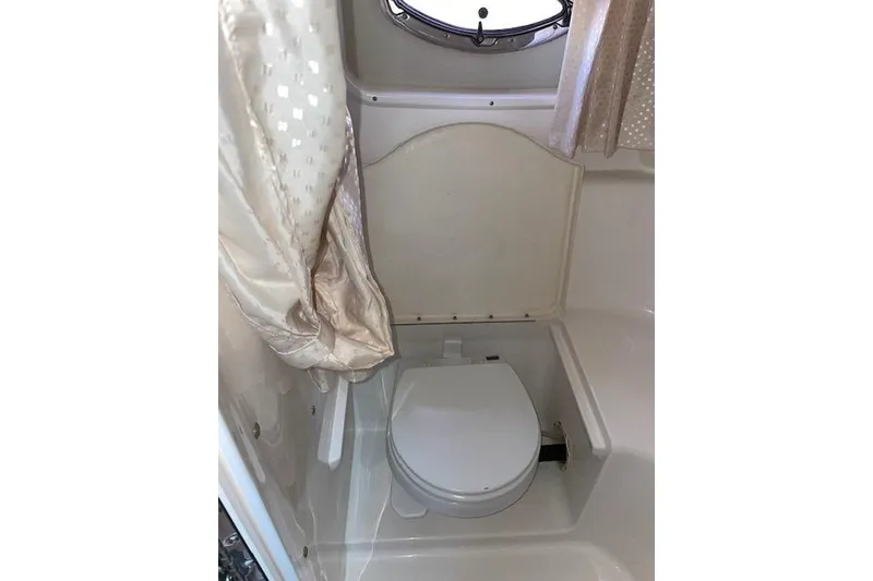 Slide: The Image of 2007 Chaparral 330 Signature boat bathroom with toilet and curtain. - 20