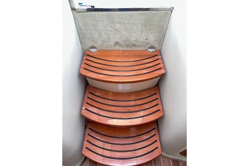 Slide: The Image of Wooden steps inside 2007 Chaparral 330 Signature boat, featuring sleek design and non-slip grooves. - 22