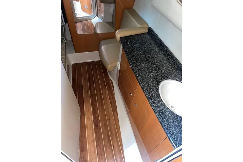Slide: The Image of 2007 Chaparral 330 Signature boat interior with wood flooring and granite countertop. - 23