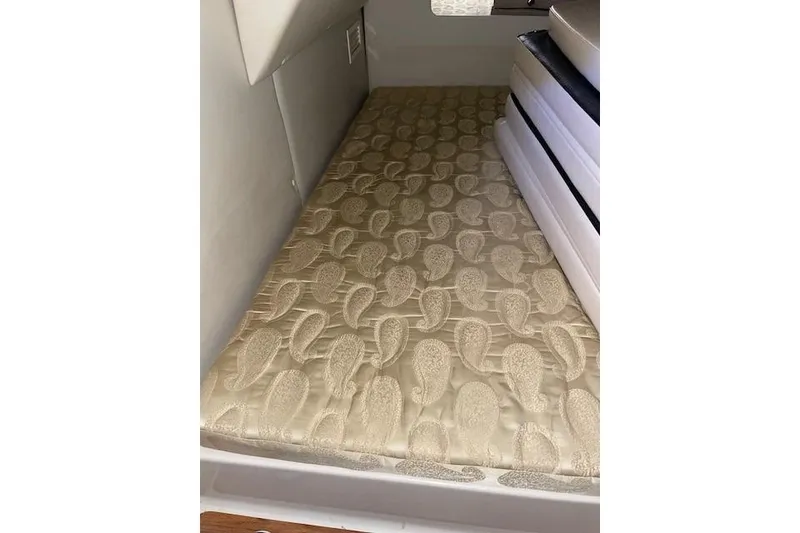 Slide: The Image of 2007 Chaparral 330 Signature cabin interior with patterned beige mattress. - 24