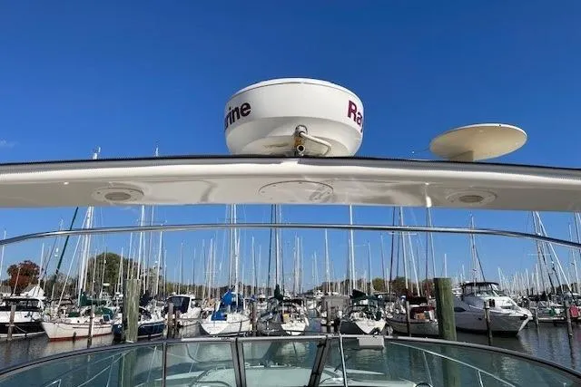Slide: The Image of 2007 Chaparral 330 Signature boat docked in a marina with clear blue sky. - 3