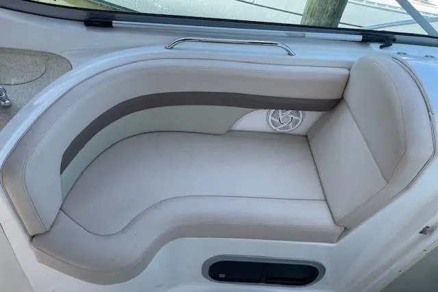 Slide: The Image of 2007 Chaparral 330 Signature boat interior seating with beige upholstery and built-in speaker. - 9