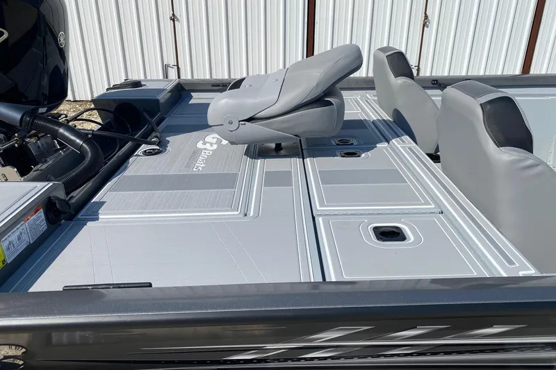 Slide: The Image of 2026 G3 Sportsman 1910SE boat interior with gray seating and storage compartments. - 10