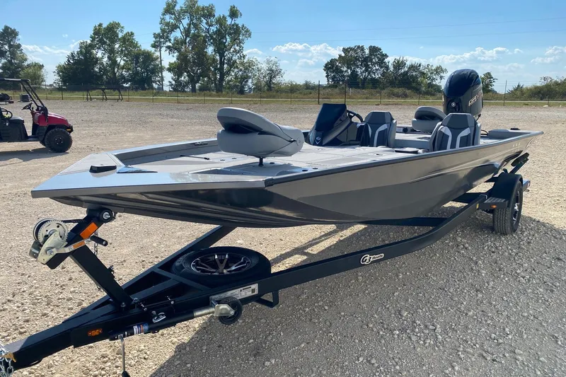 Slide: The Image of 2026 G3 Sportsman 1910SE fishing boat on trailer, parked outdoors. - 2