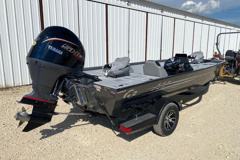 Slide: The Image of 2026 G3 Sportsman 1910SE boat with Yamaha engine, parked outdoors. - 5