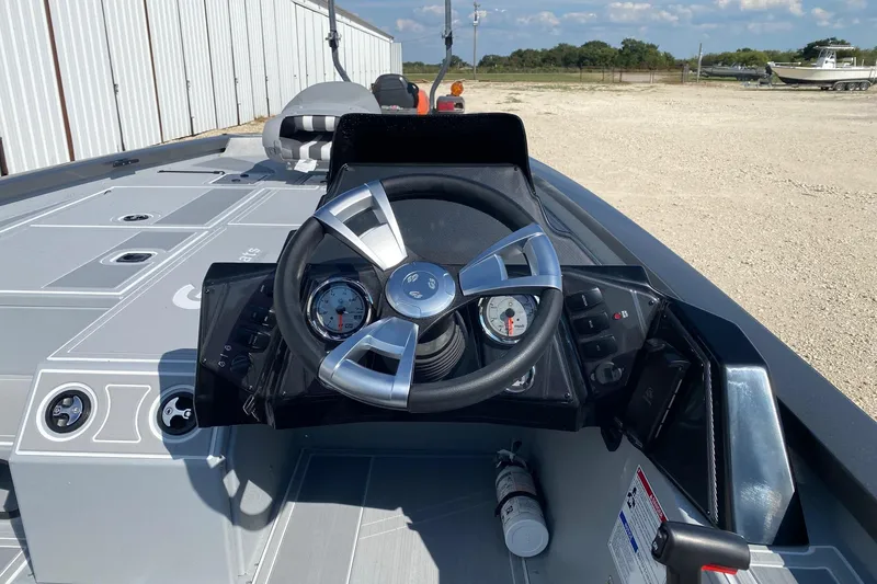 Slide: The Image of 2026 G3 Sportsman 1910SE boat dashboard with steering wheel and gauges. - 6