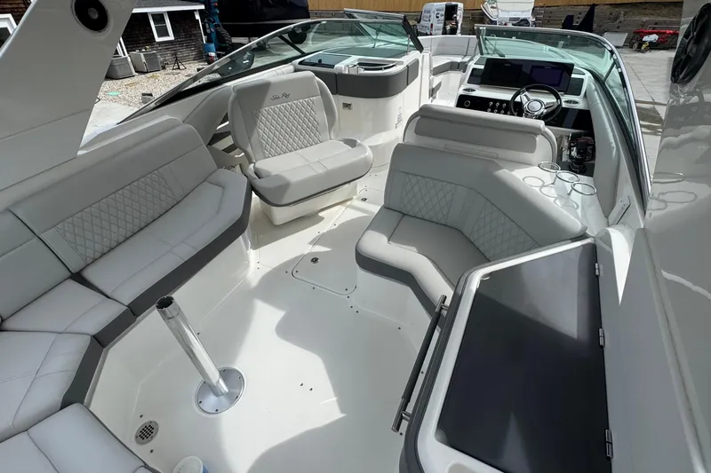 Slide: The Image of Luxurious interior of 2021 Sea Ray 310 SLX boat with plush seating and modern dashboard. - 11