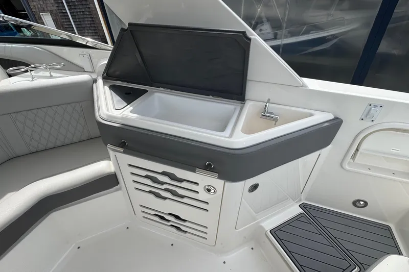 Slide: The Image of Interior of 2021 Sea Ray 310 SLX boat featuring a sleek kitchenette area. - 15