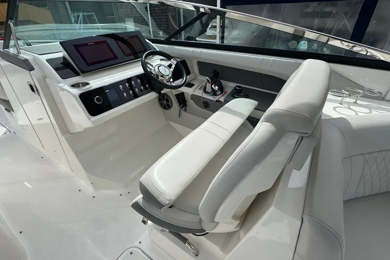 Slide: The Image of Luxurious interior of 2021 Sea Ray 310 SLX boat with modern dashboard and seating. - 16
