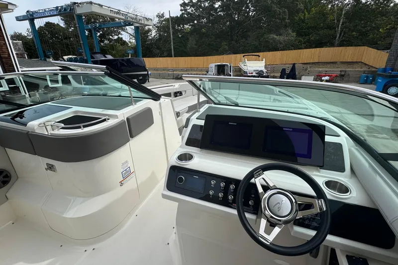 Slide: The Image of 2021 Sea Ray 310 SLX boat cockpit with modern controls and dual displays. - 17