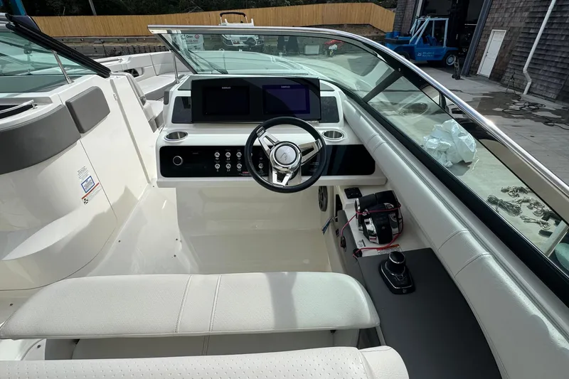 Slide: The Image of 2021 Sea Ray 310 SLX boat cockpit with modern steering and control panel. - 18