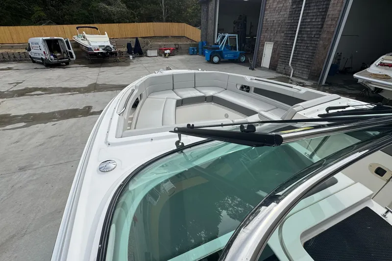 Slide: The Image of 2021 Sea Ray 310 SLX boat with spacious seating, parked in a marina. - 26