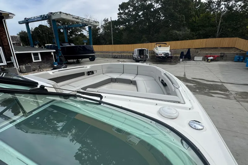 Slide: The Image of 2021 Sea Ray 310 SLX boat with spacious seating, docked at a marina. - 28